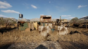 an old run down building in a dry field