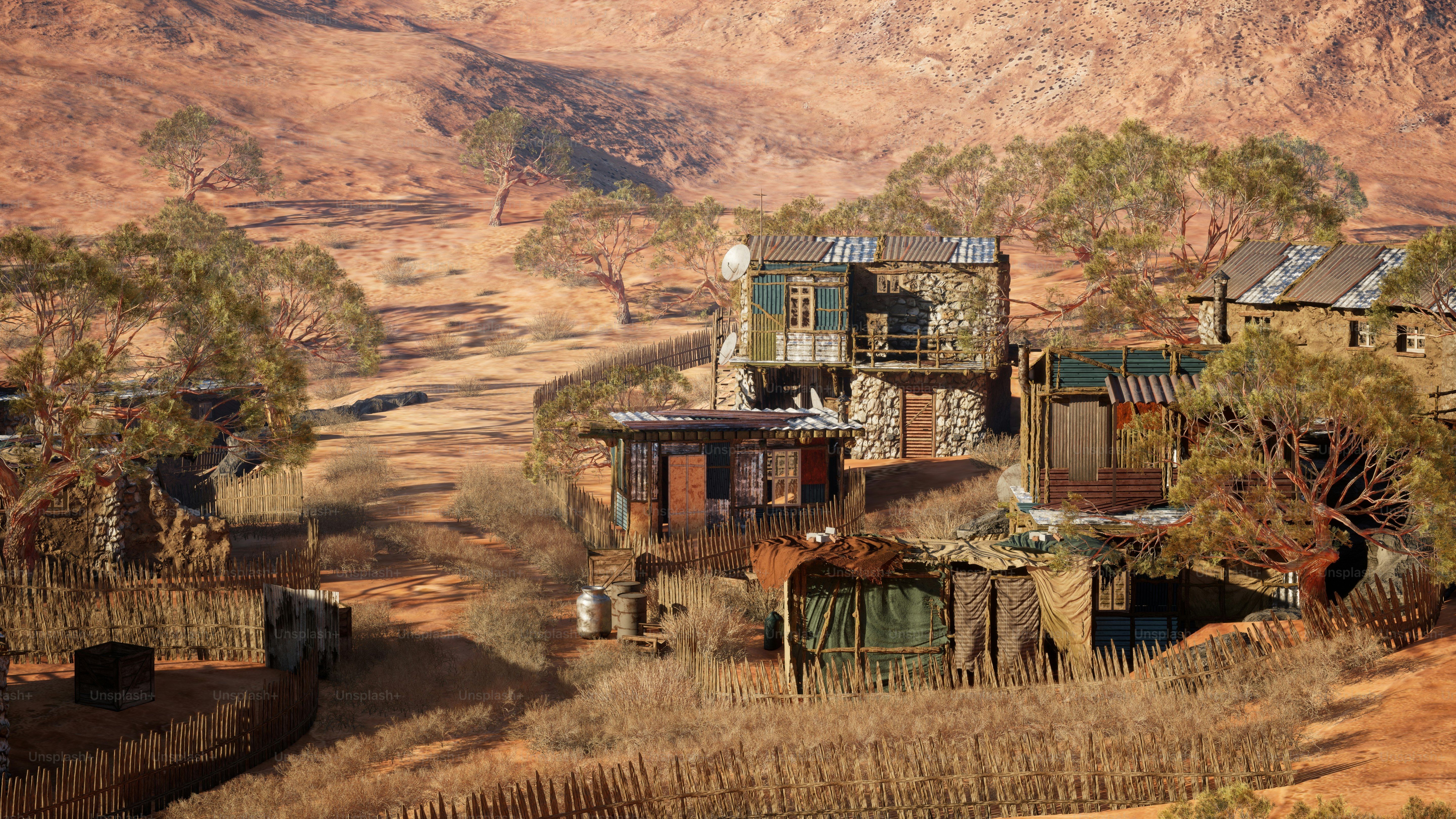 a group of buildings sitting on top of a dry grass field