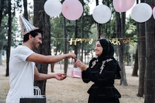 a man handing a woman a birthday card