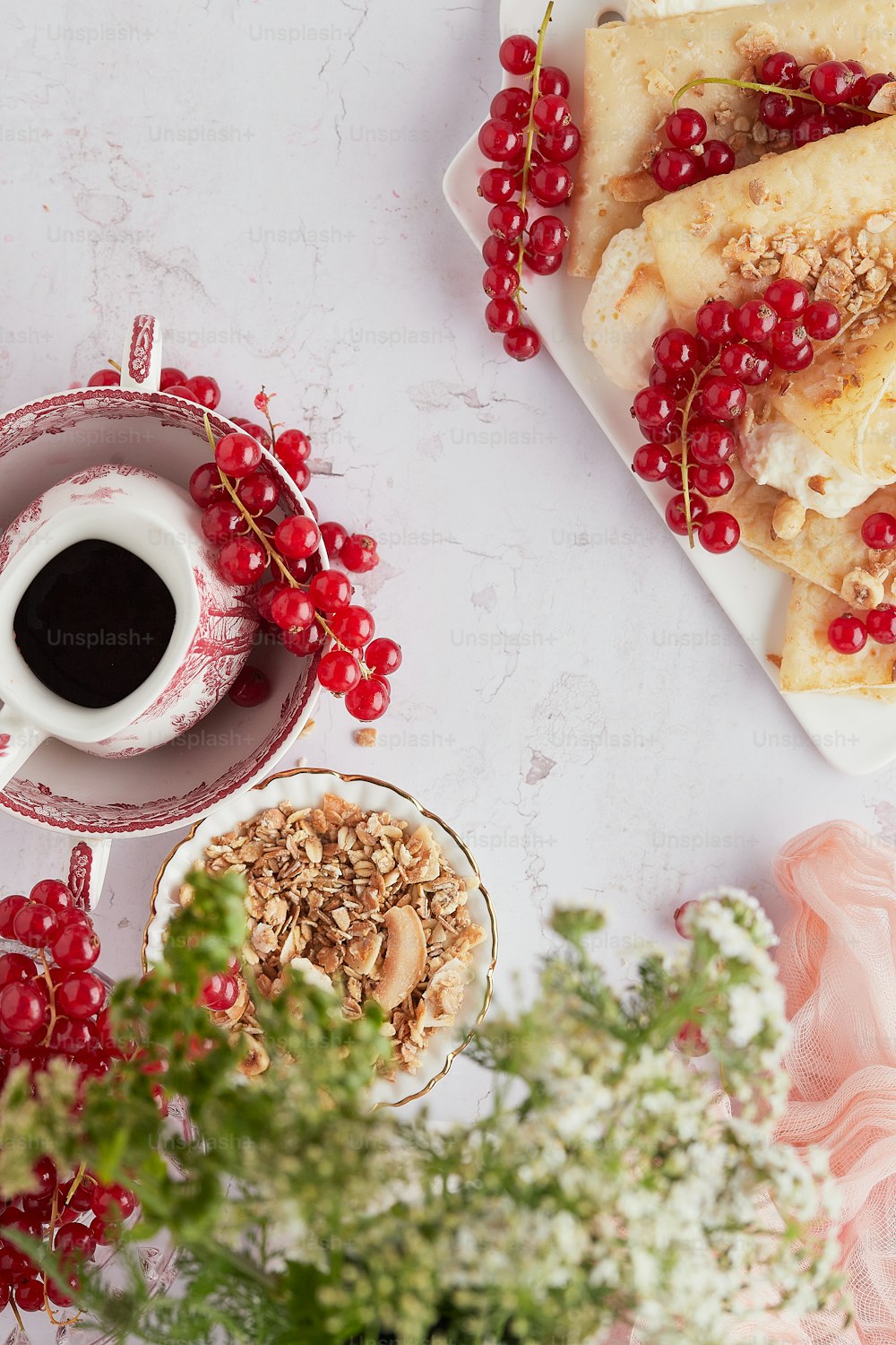 a plate of food and a cup of coffee on a table