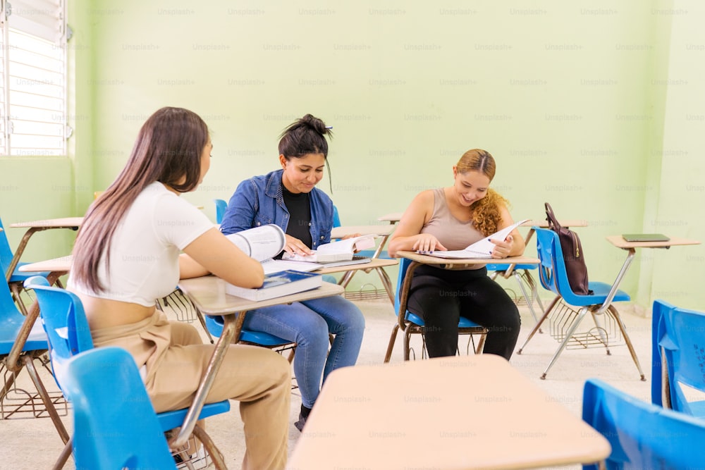a group of people sitting at desks in a classroom
