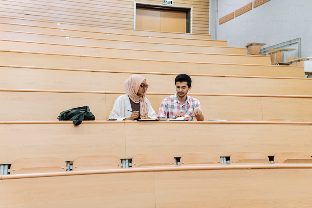 a man and a woman sitting in a lecture hall