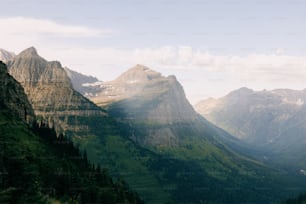 a view of a mountain range with trees and mountains in the background