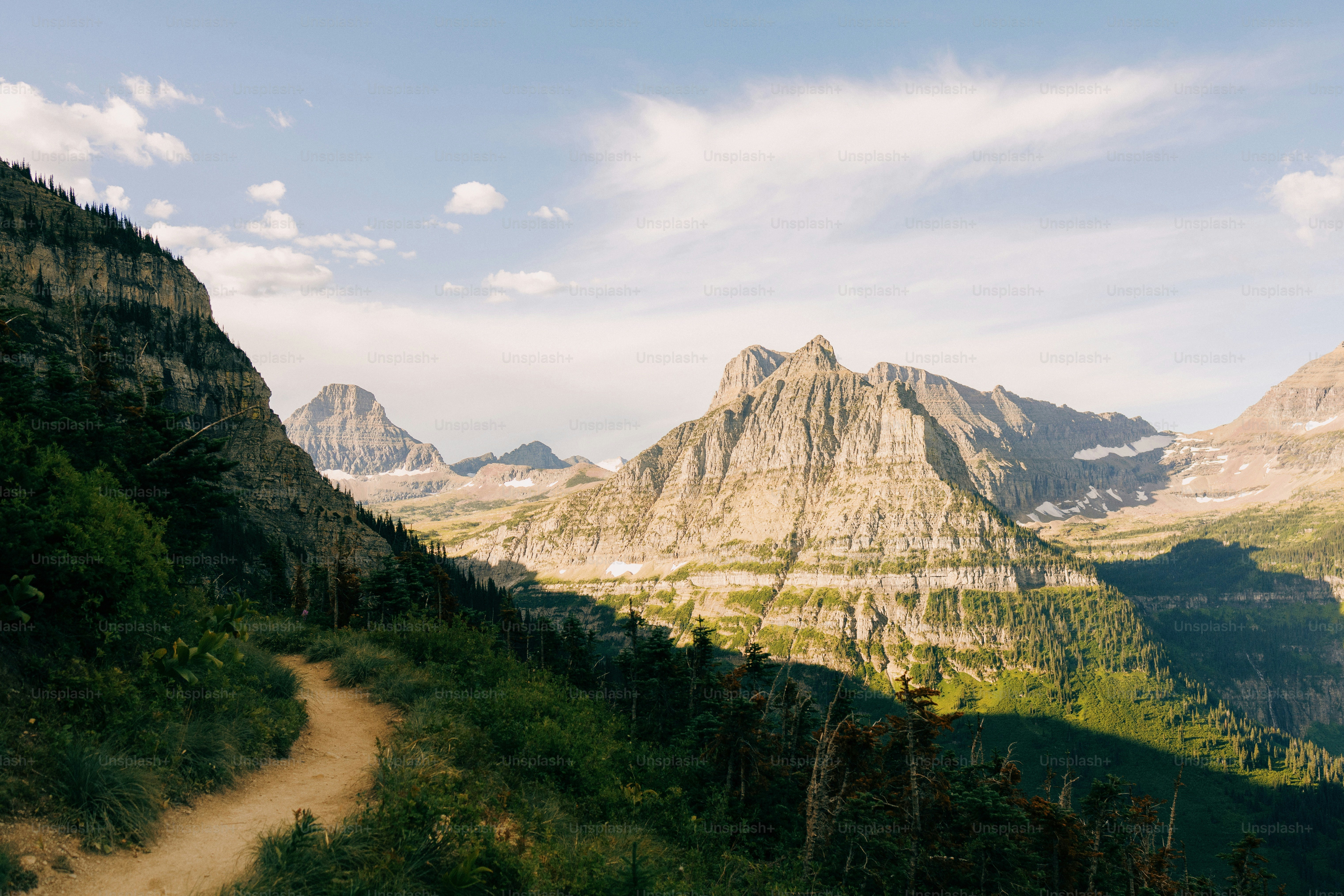 a dirt path in the middle of a mountain range