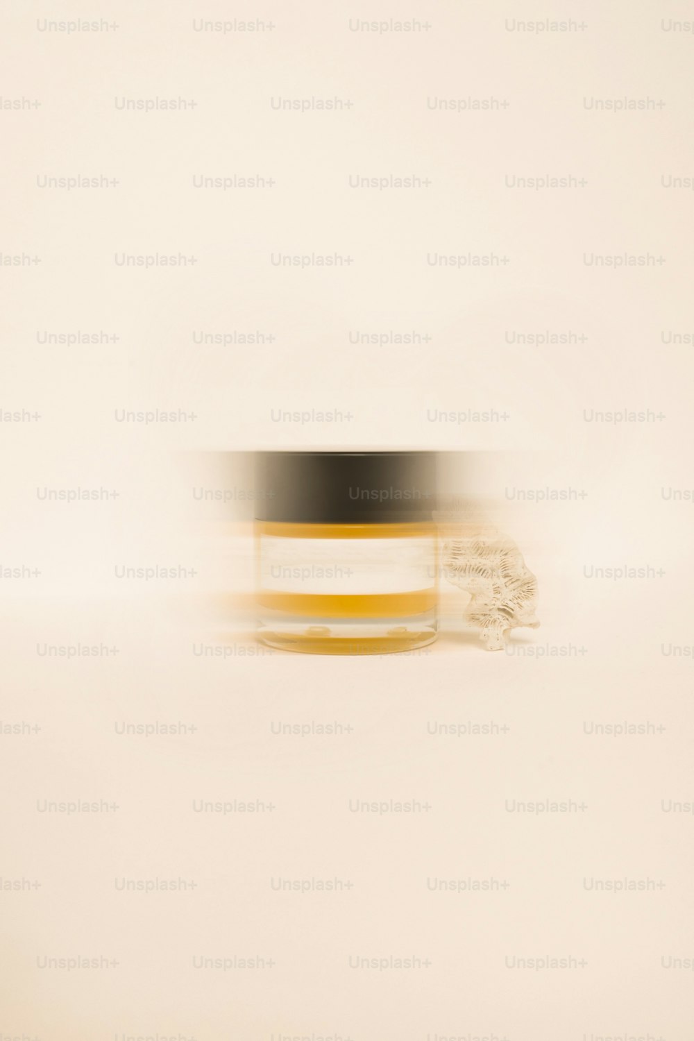 a blurry photo of a jar of cream
