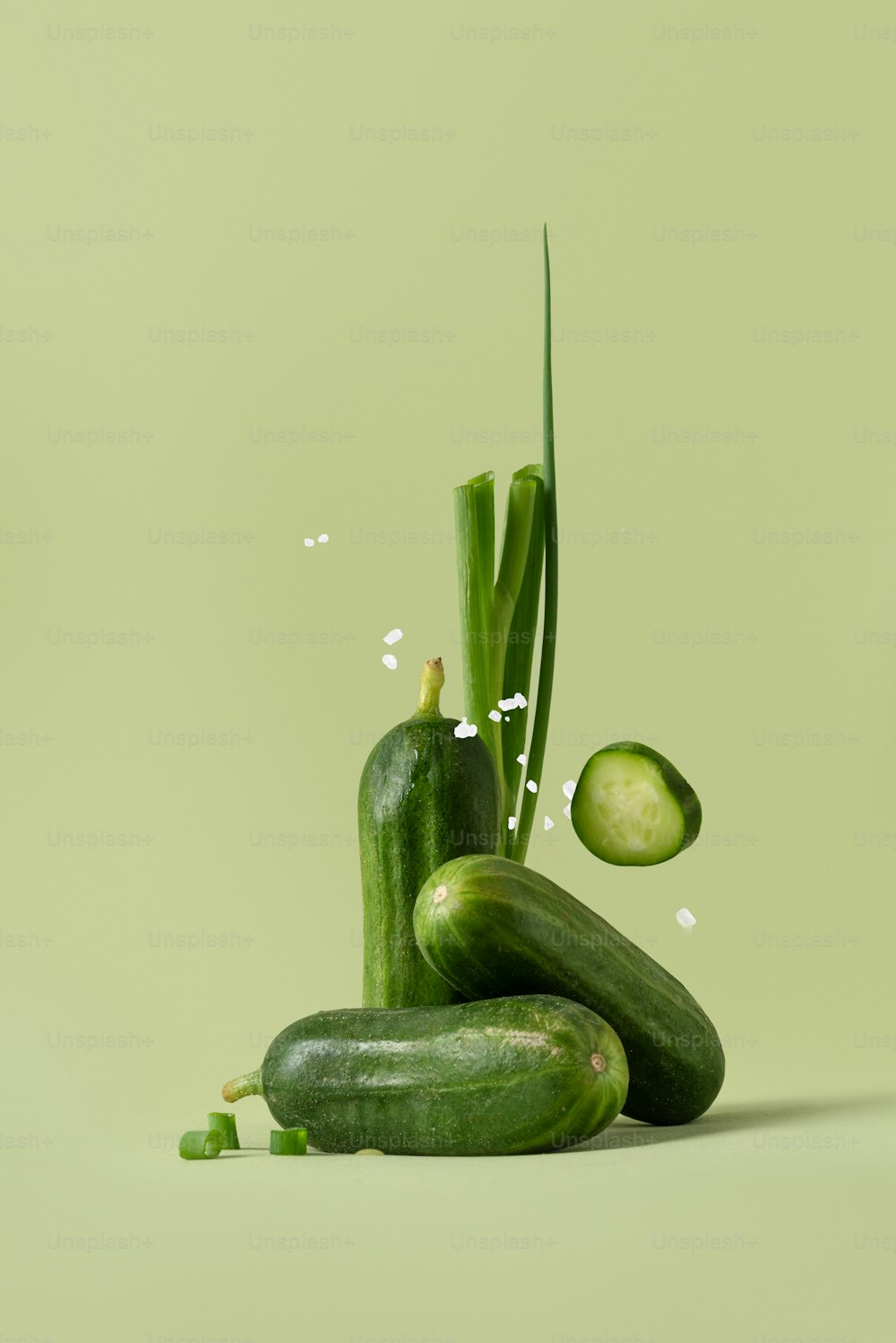 a cucumber and a cucumber on a green background