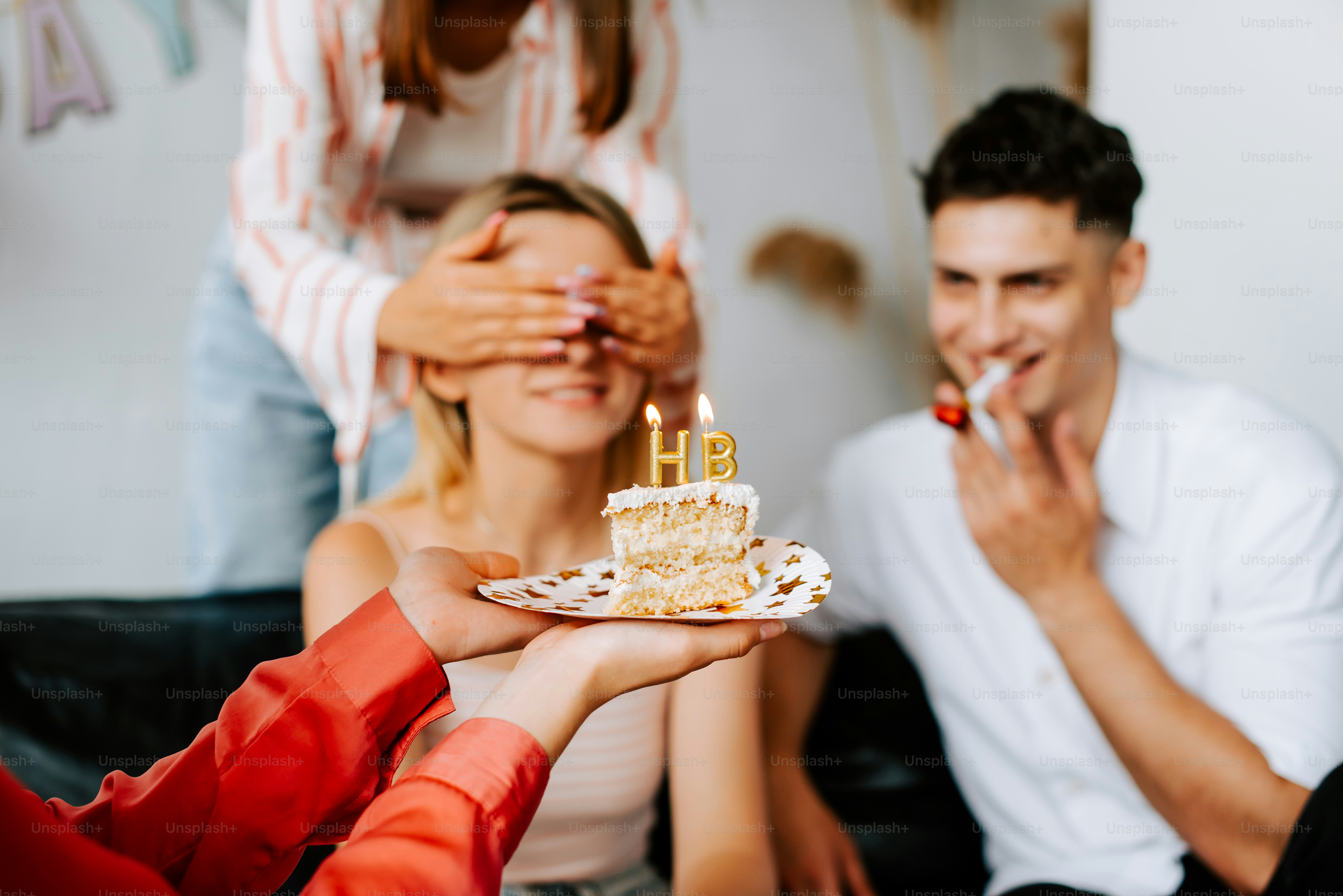 A group of people sitting around a table with a cake photo – Birthday ...