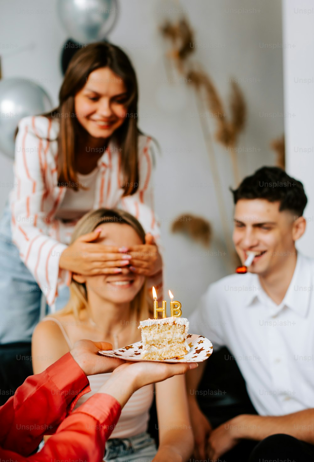 a group of people sitting around a table with a cake