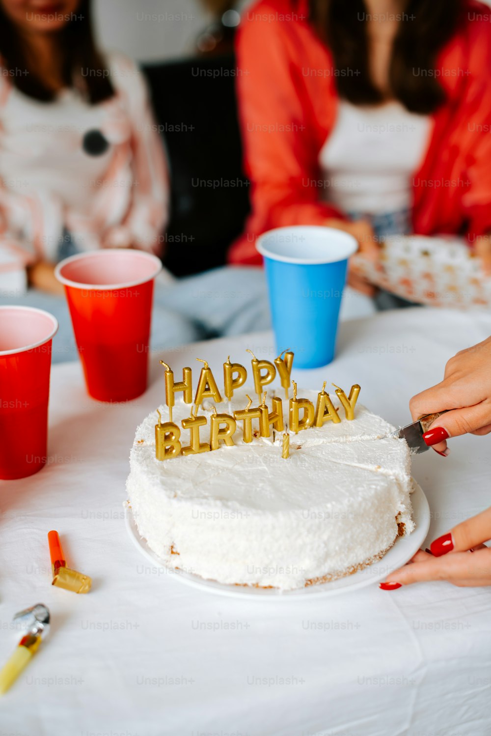 a woman cutting a birthday cake with a knife