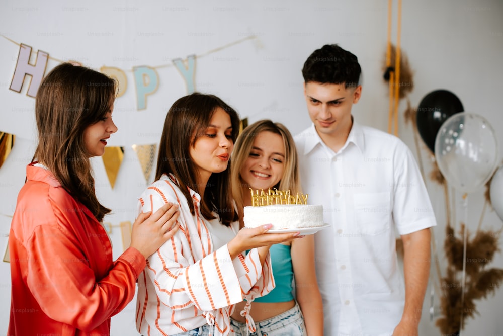a group of people standing around a cake