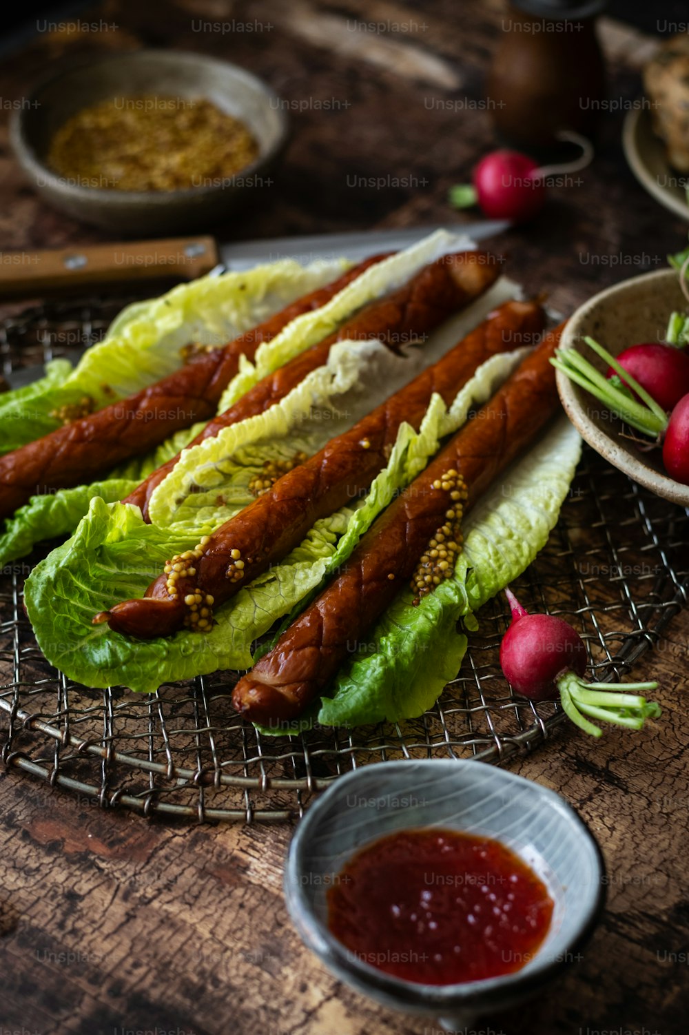 lettuce, radishes, and hotdogs on a wire rack