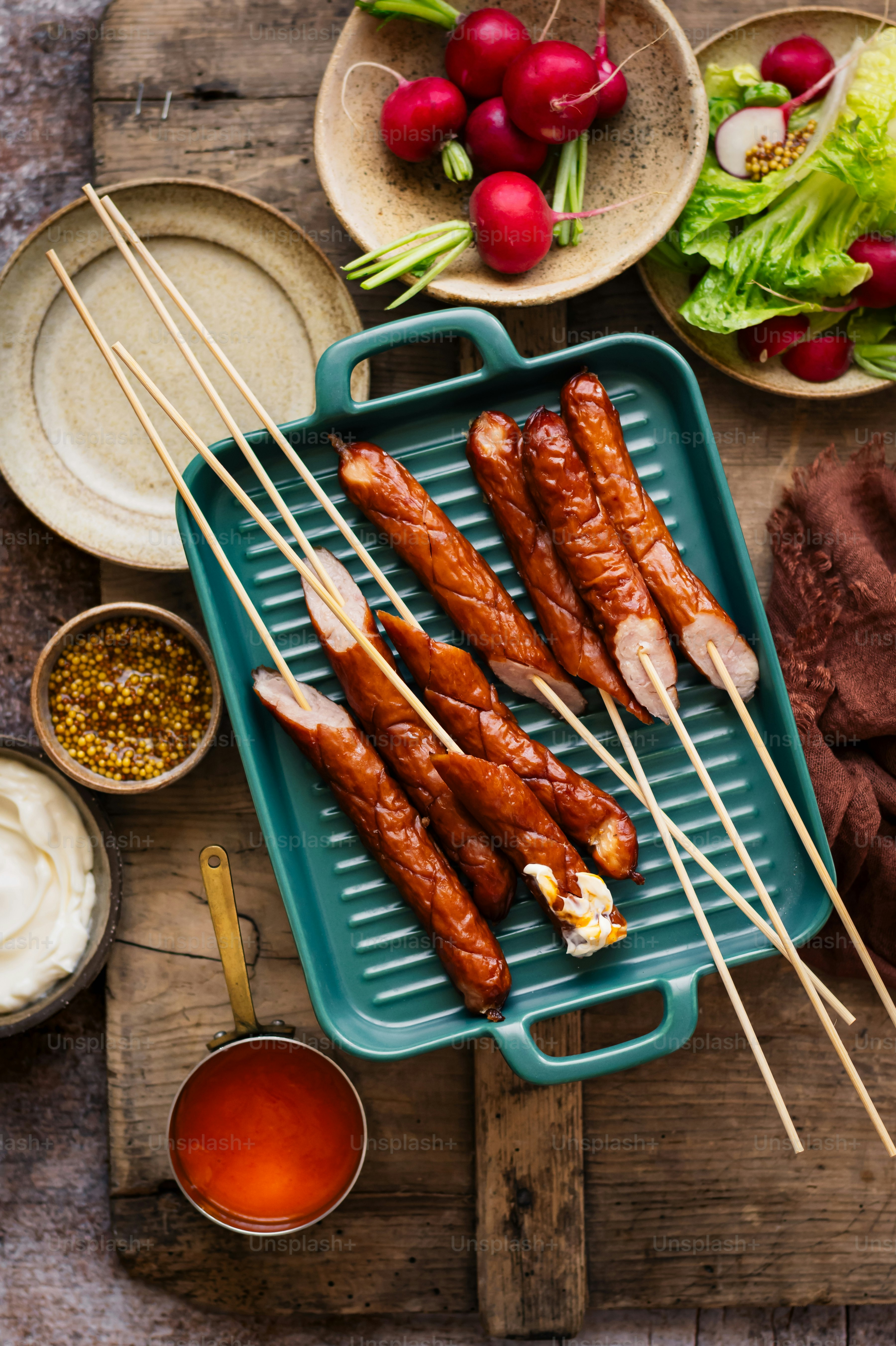 a tray of food with skewers of meat and vegetables