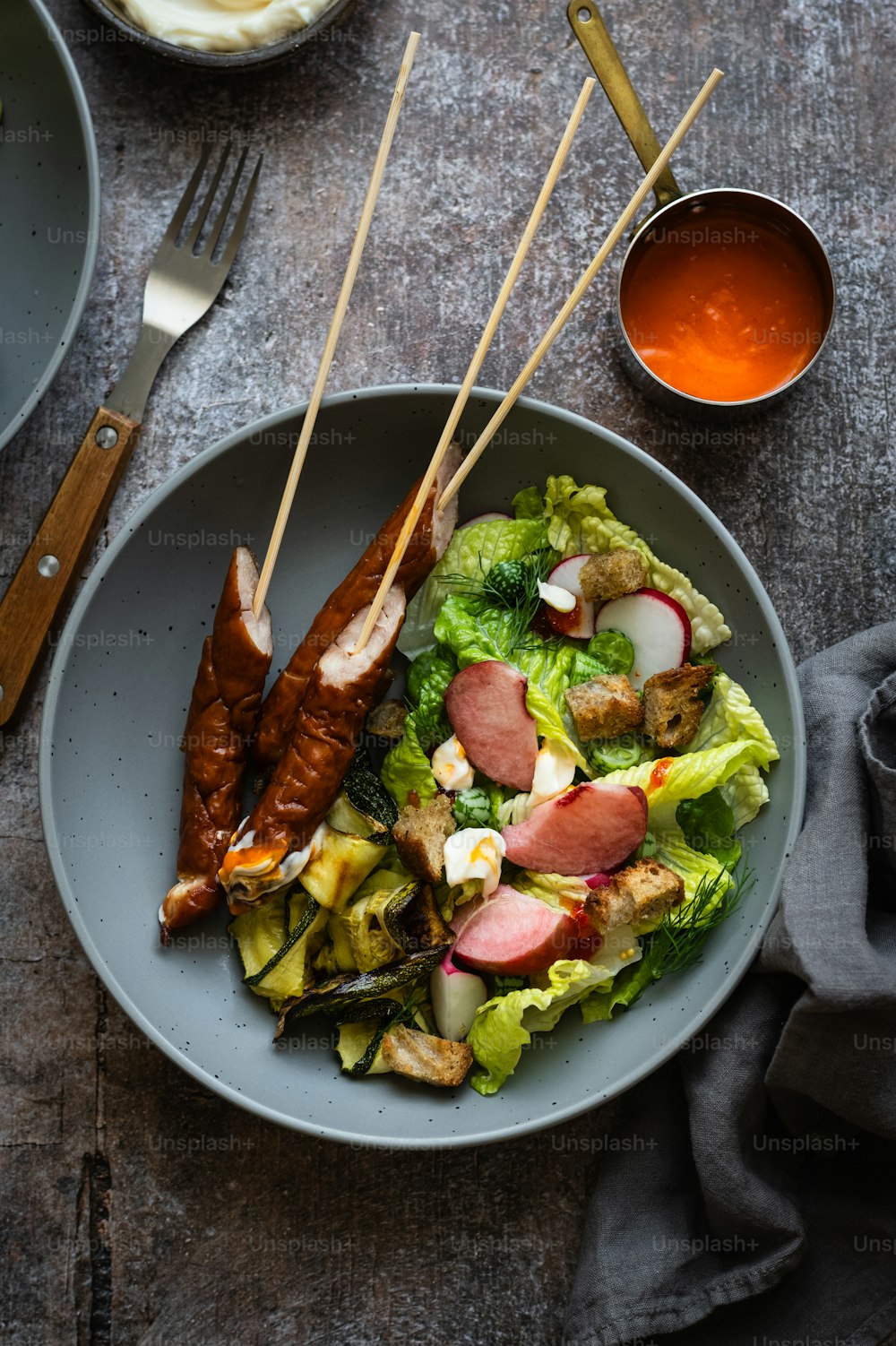 a bowl of food with chopsticks on top of it