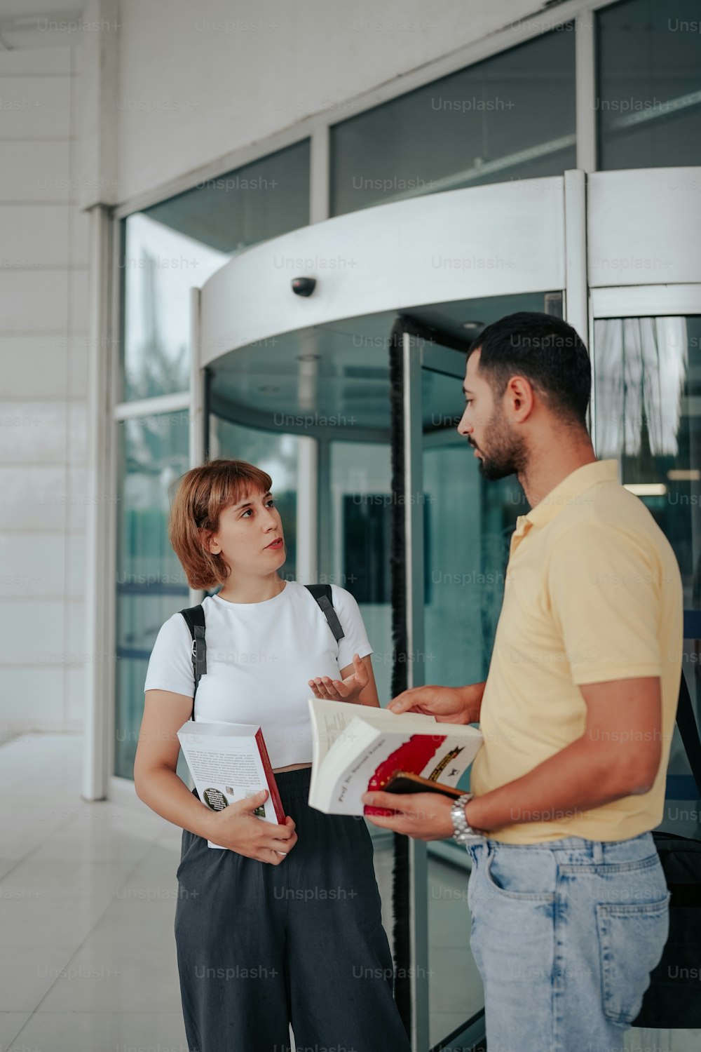 a man and a woman standing in front of a building