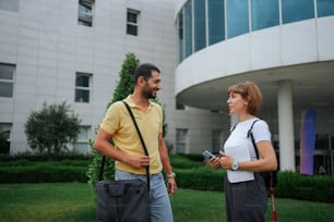 a man and a woman standing in front of a building