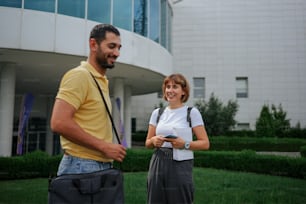 a man and a woman standing in front of a building