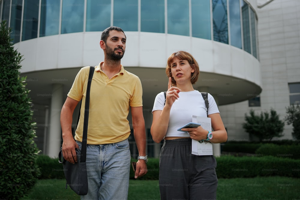 a man and a woman standing in front of a building