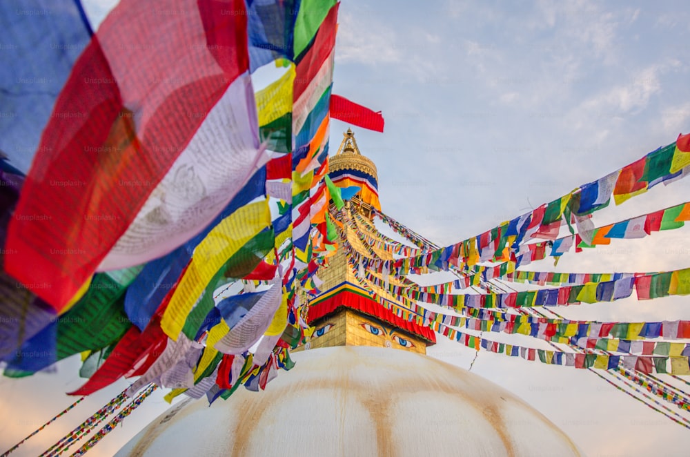 many colorful flags are flying in the air