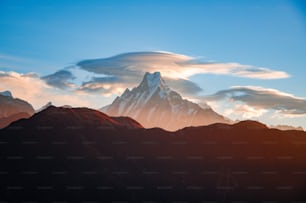 a group of mountains with clouds in the sky