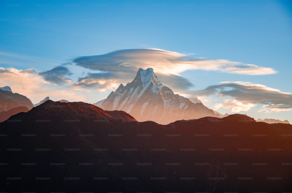 a group of mountains with clouds in the sky