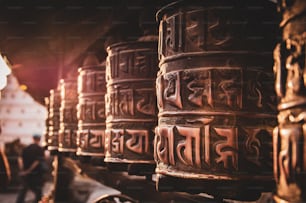 a row of metal bells with writing on them