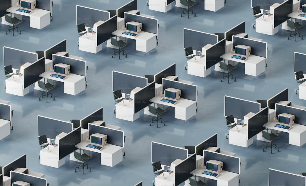 a group of cubicles with computers and desks