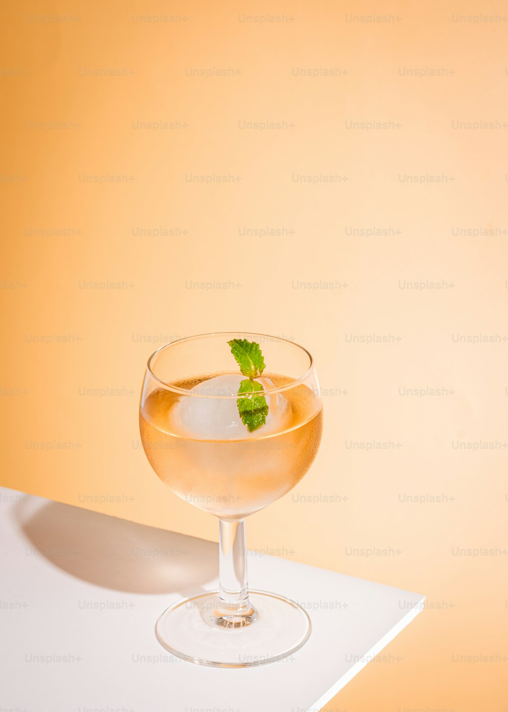 a glass filled with a drink sitting on top of a table