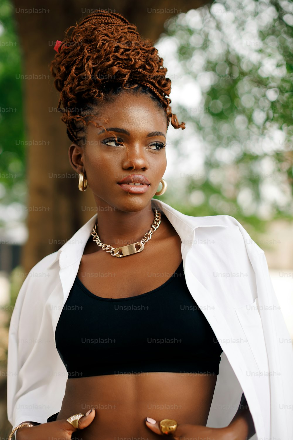 a woman in a black bikini top and a white jacket