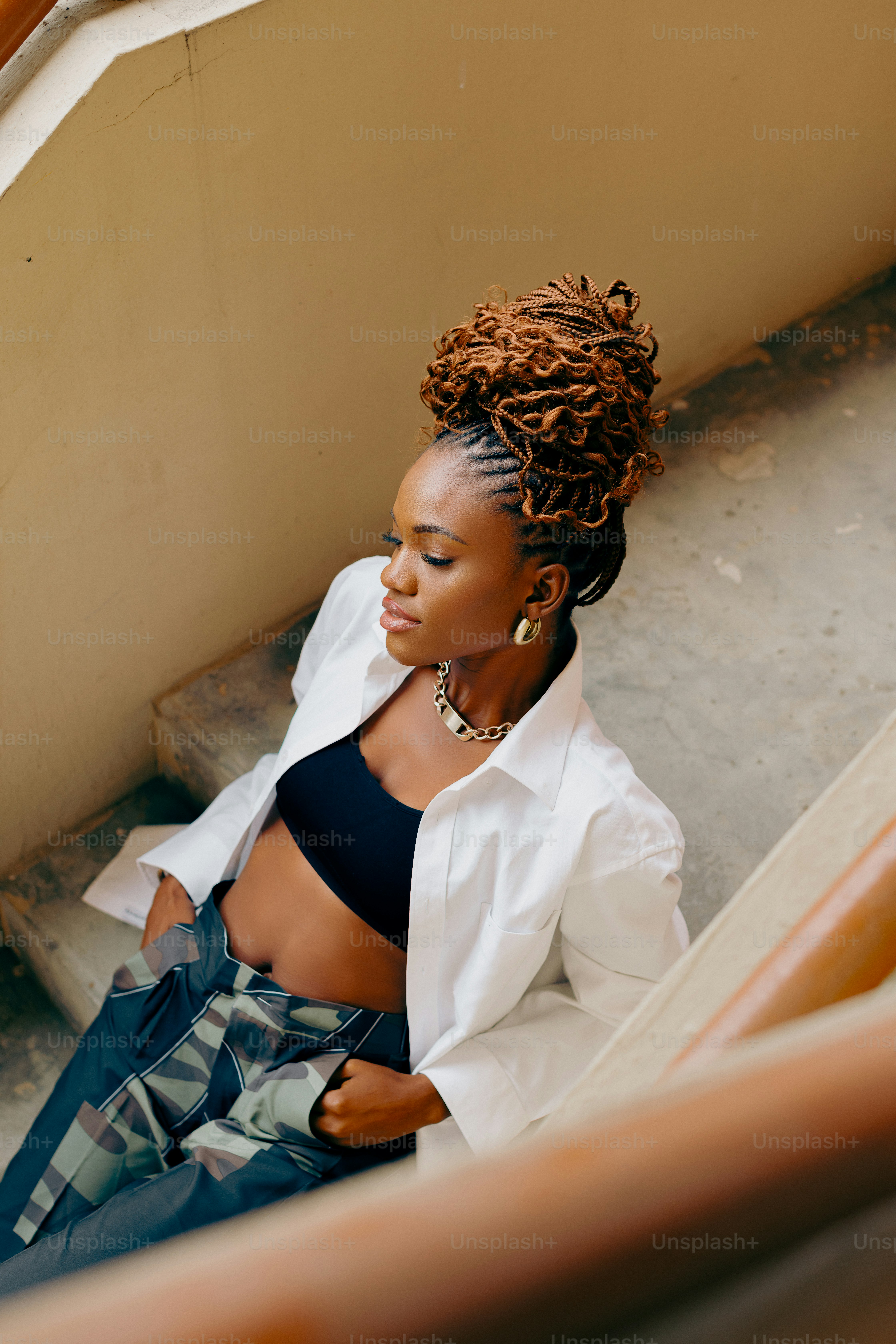a woman sitting on the steps of a building