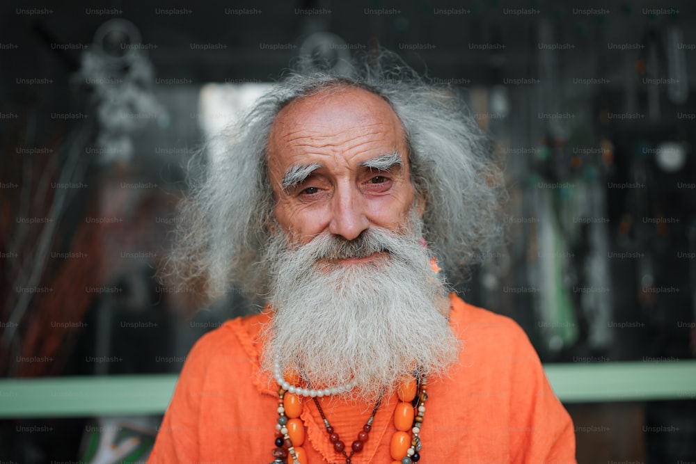 an old man with a long beard wearing a necklace