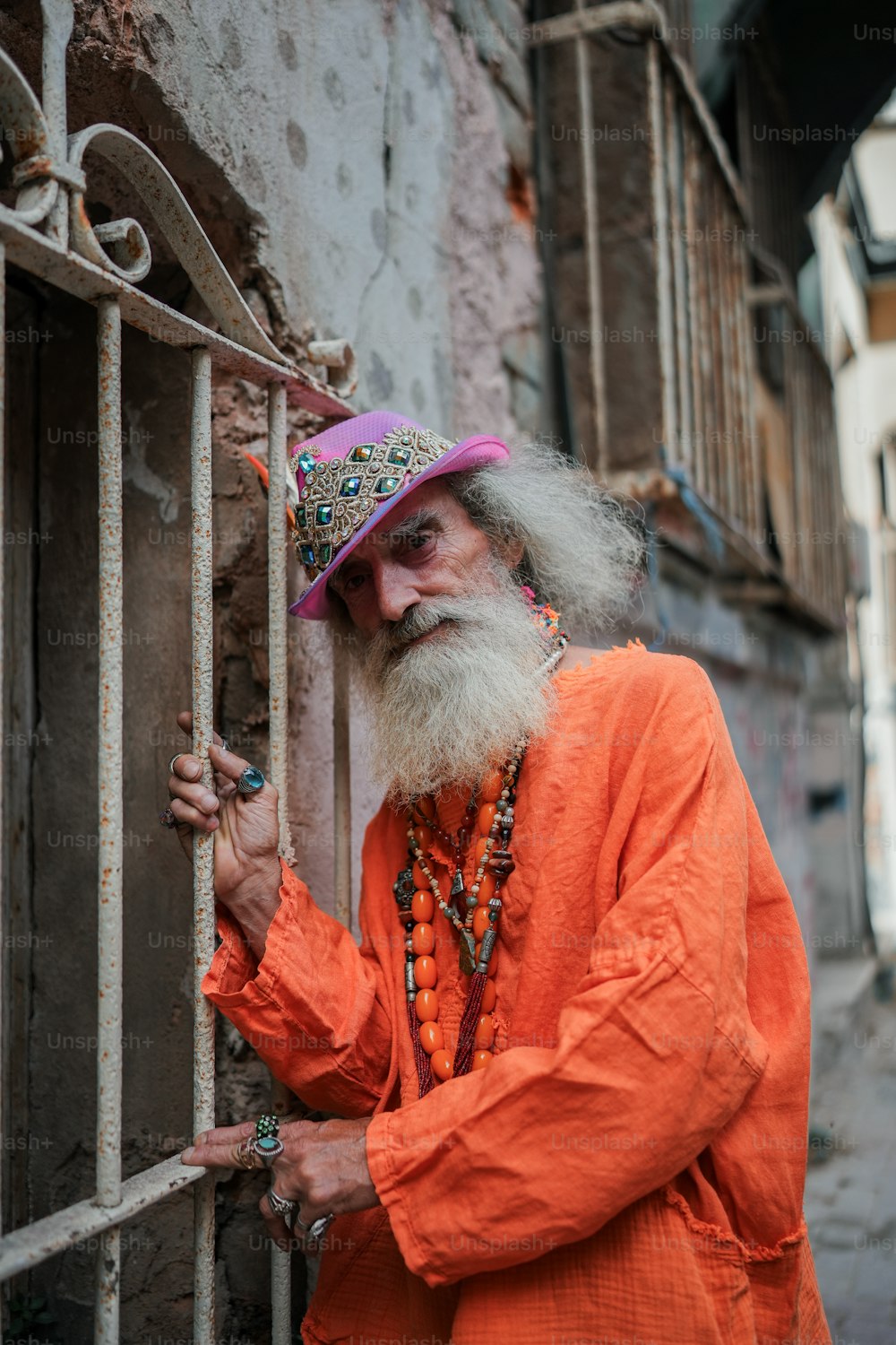a man with a long white beard wearing an orange outfit