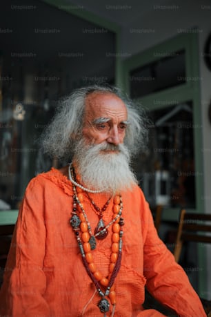 an old man with a long beard wearing a necklace