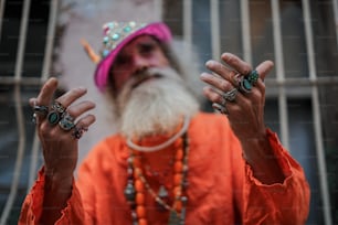 a man with a long white beard wearing rings