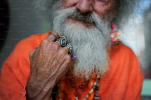 a man with a long white beard wearing a ring