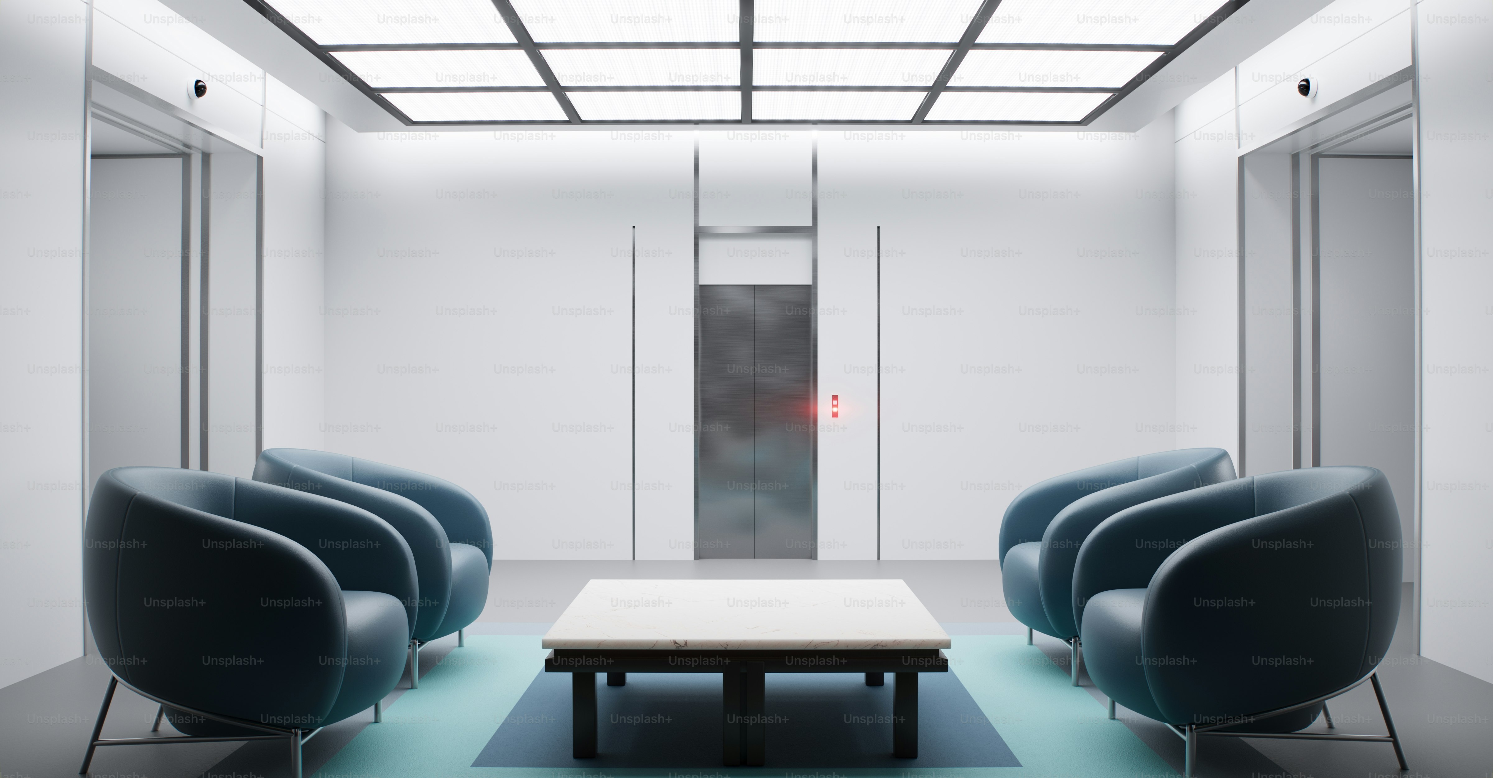 a white room with blue chairs and a coffee table