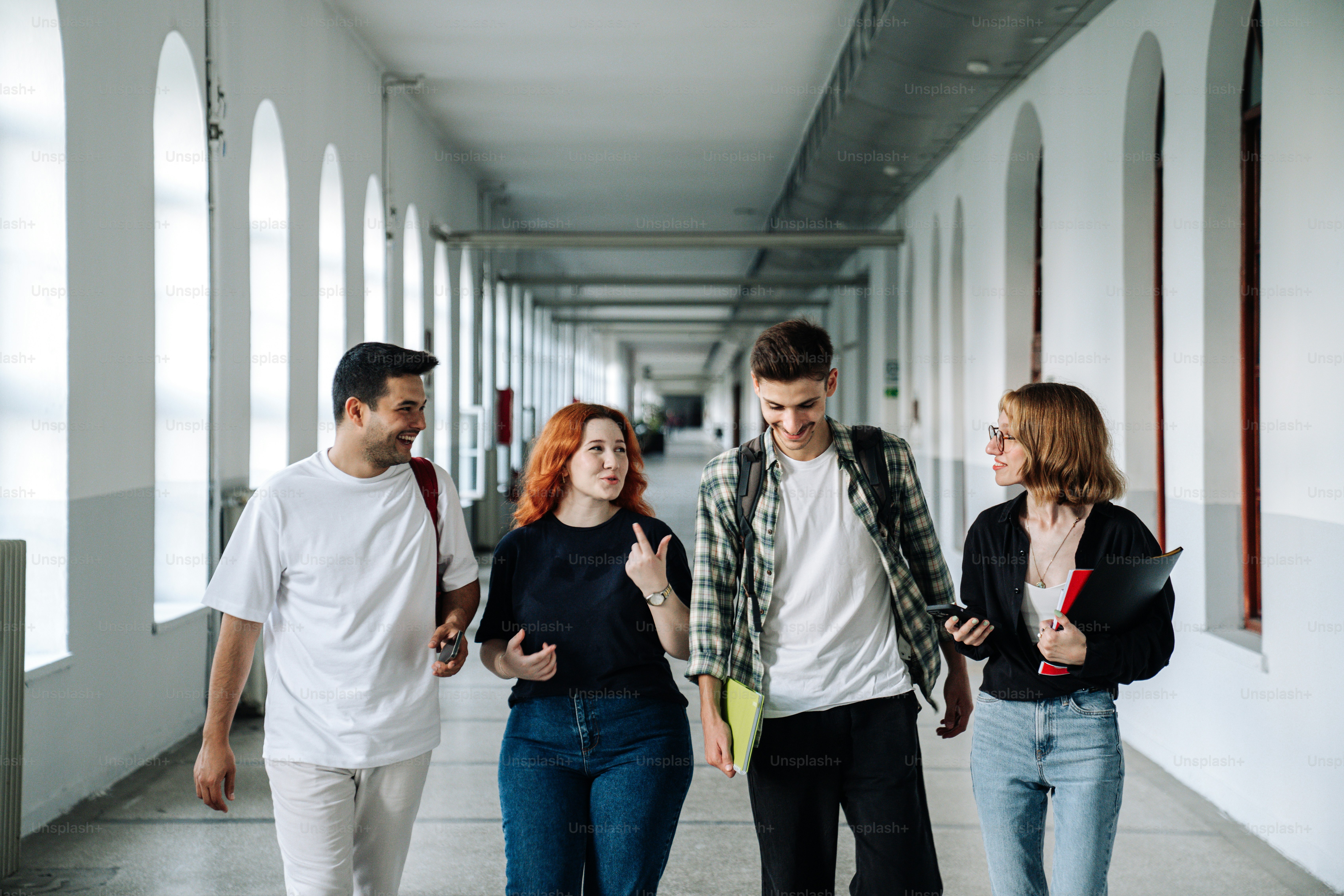 a group of young people walking down a hallway