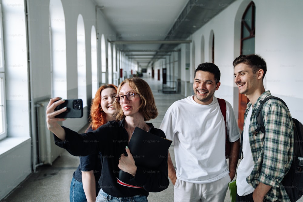 a group of people taking a selfie in a hallway