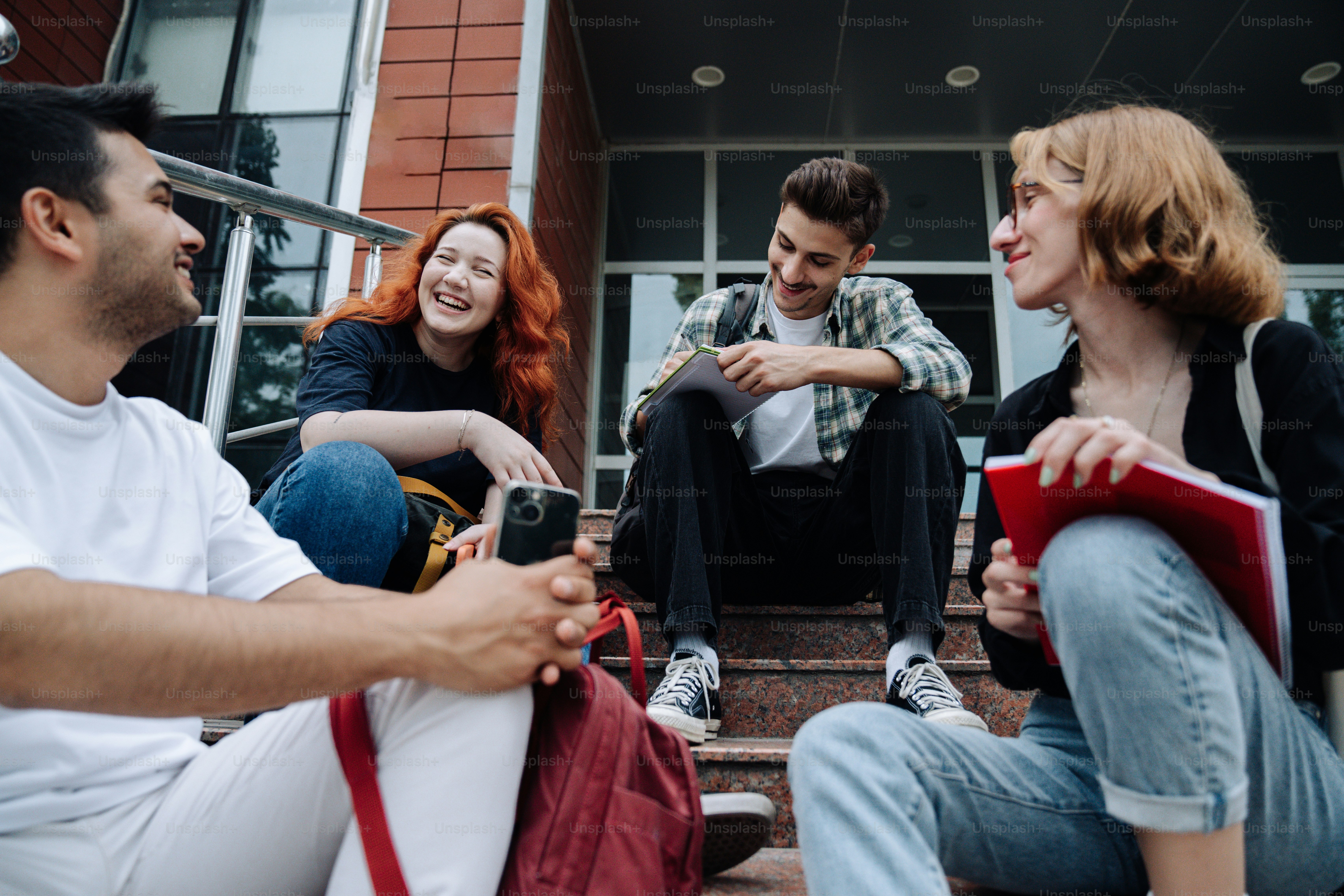a group of people sitting on the steps of a building