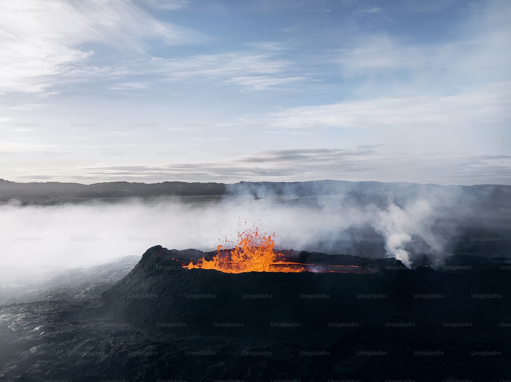 a volcano with lava and steam rising from it