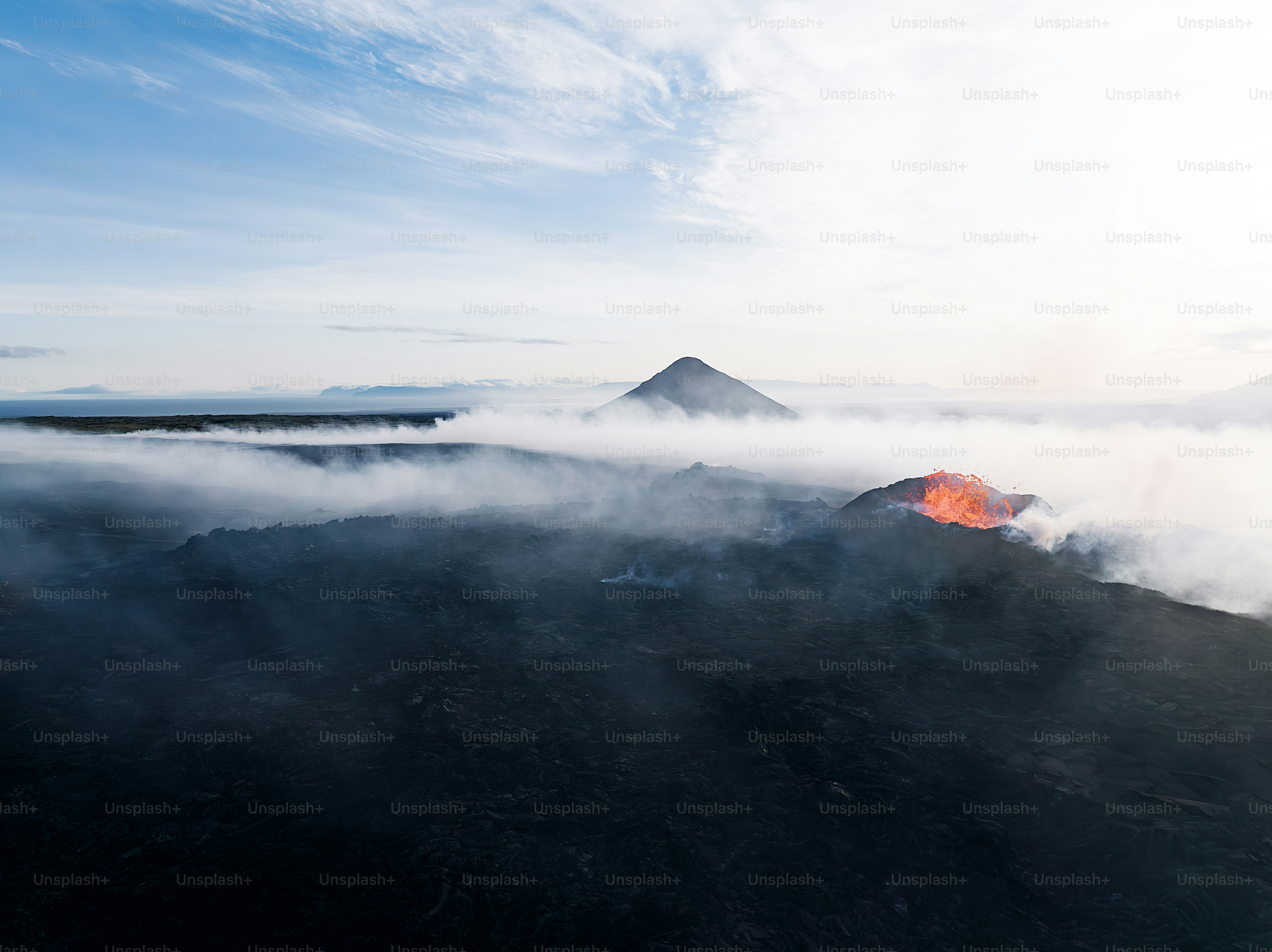 a view of a mountain with a lot of clouds around it