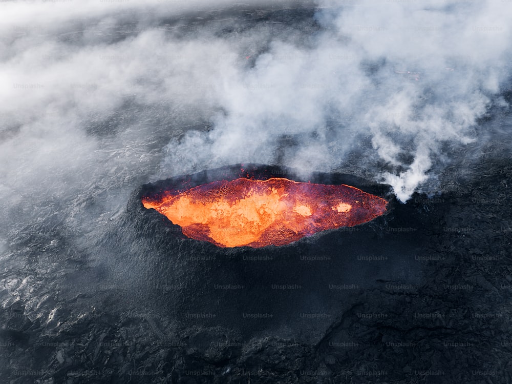 an aerial view of an active volcano in the ocean