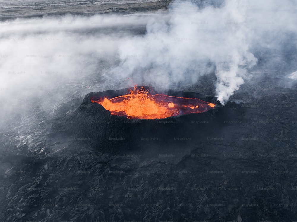 an aerial view of a lava lake with steam rising from it