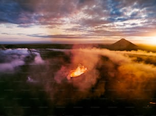 a large fire burning in the middle of a forest