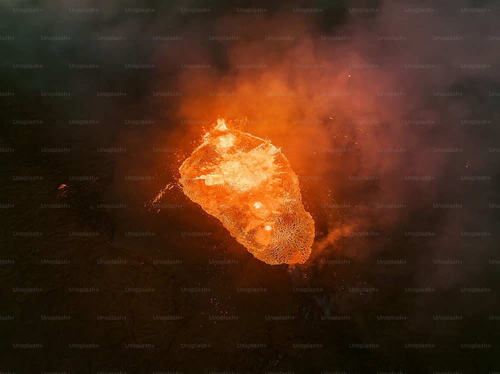 an aerial view of a rock on fire