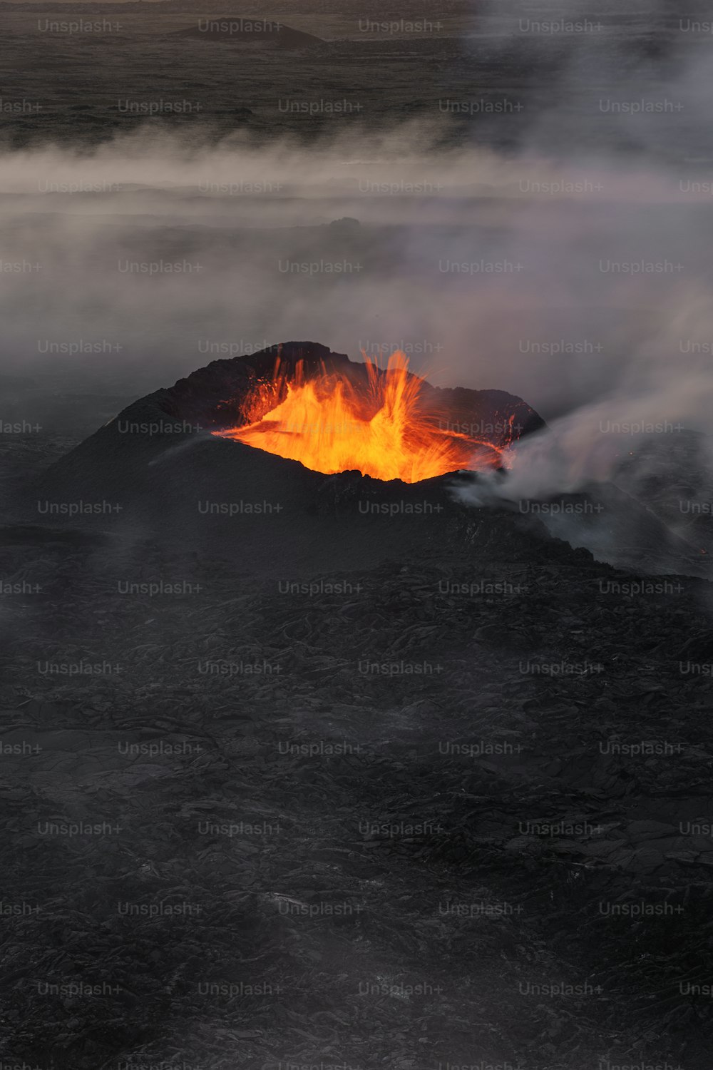 a volcano spewing out lava into the air