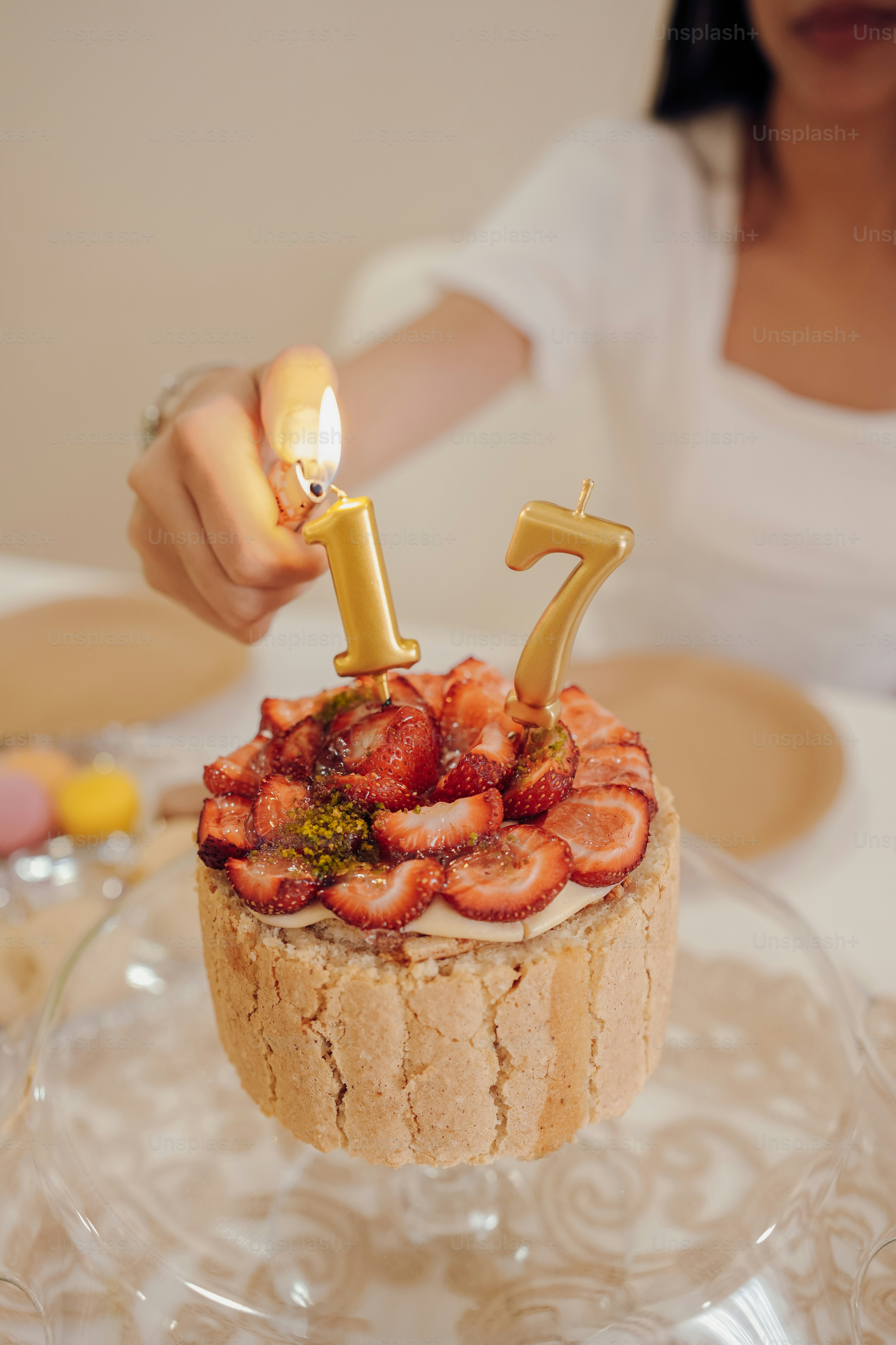 a woman lighting a candle on top of a cake