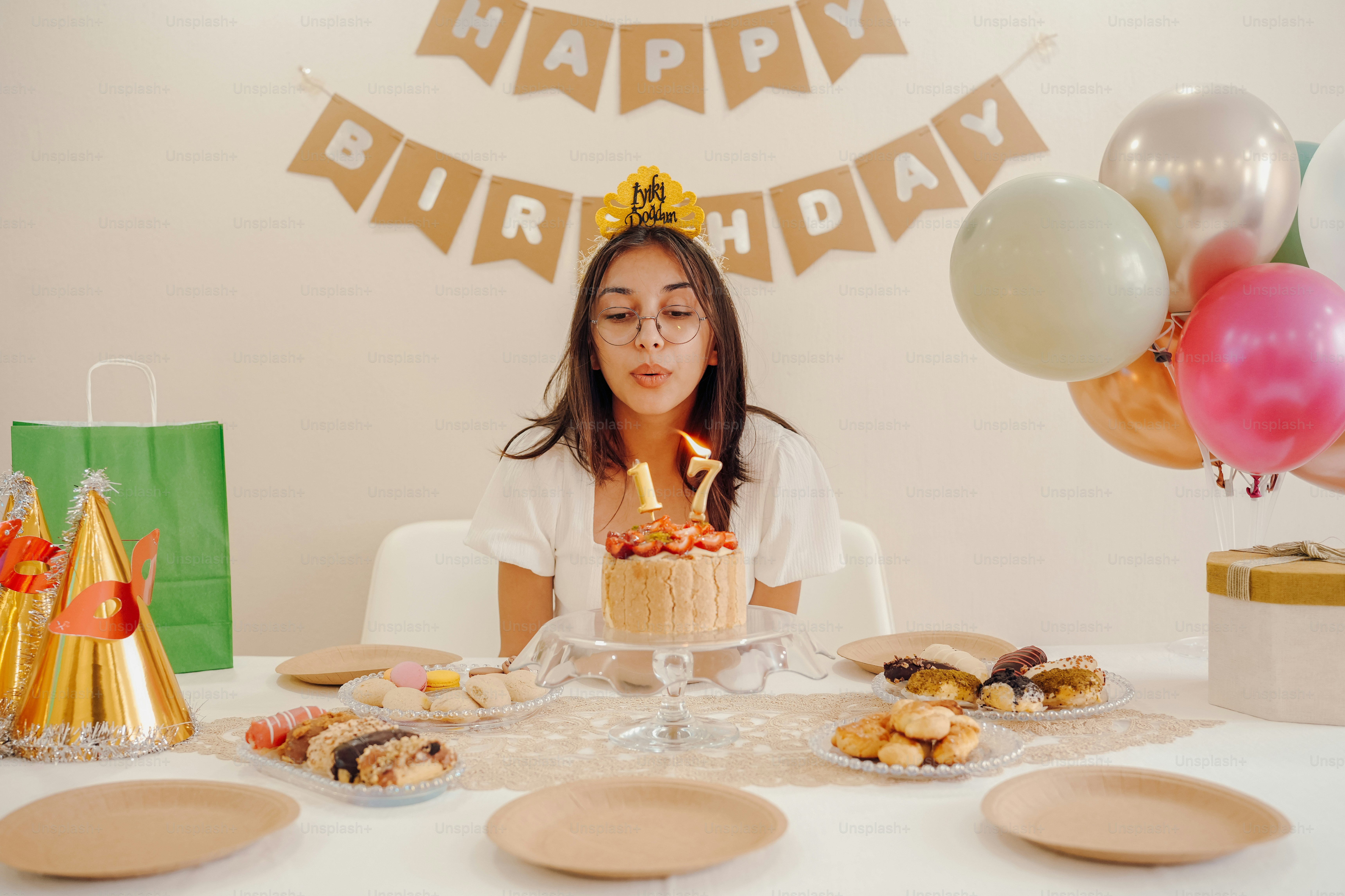 a woman sitting at a table with a birthday cake