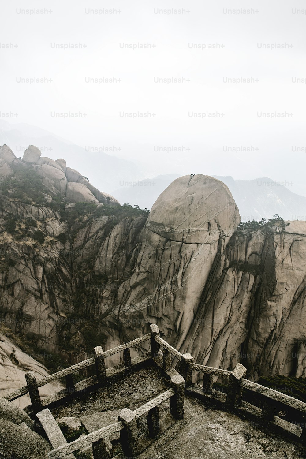 a view of a rocky mountain with a wooden fence