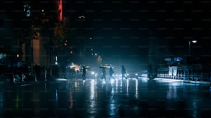 a group of people walking down a street at night