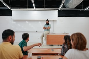 a man standing in front of a class room full of people